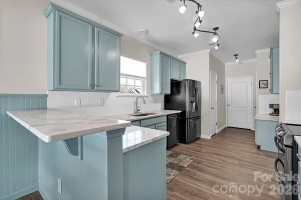 a kitchen with a refrigerator a sink and a stove