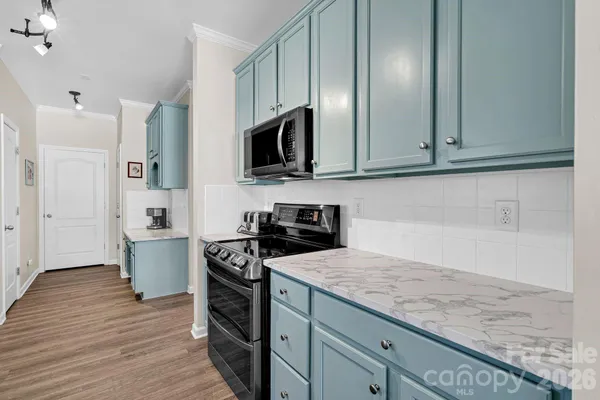 a kitchen with a sink microwave and refrigerator