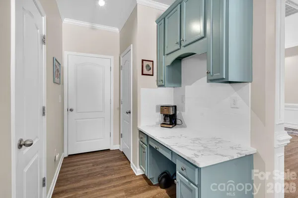 a kitchen with granite countertop cabinets and utility room
