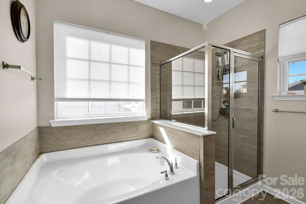 a bathroom with a bathtub and a shower