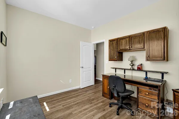 a view of kitchen with cabinets and wooden floor