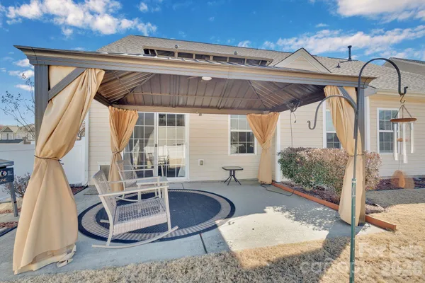 a building outdoor space with patio furniture and potted plants