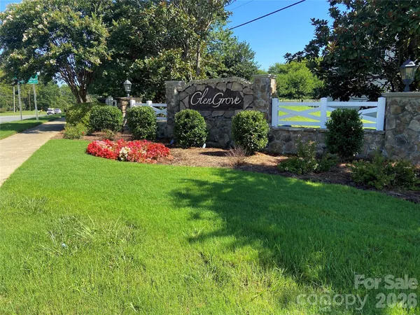 a front view of a house with swing and trees