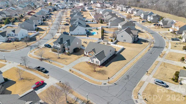 an aerial view of a house with a swimming pool