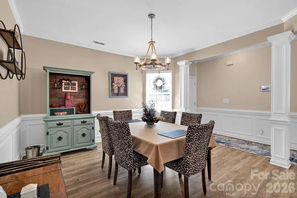 a dining room with furniture a chandelier and window
