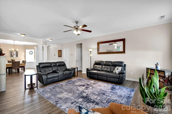 a living room with furniture rug and wooden floor