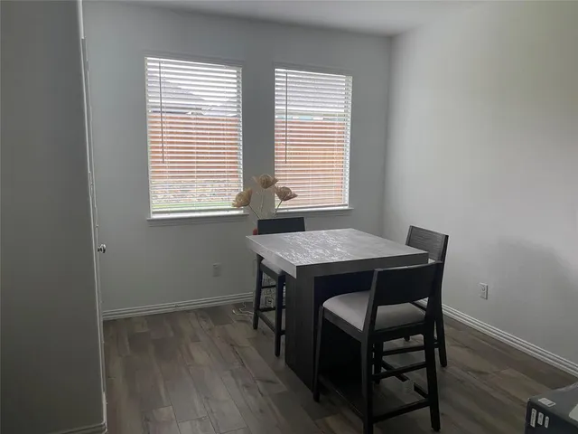 a dining room with a table and chairs