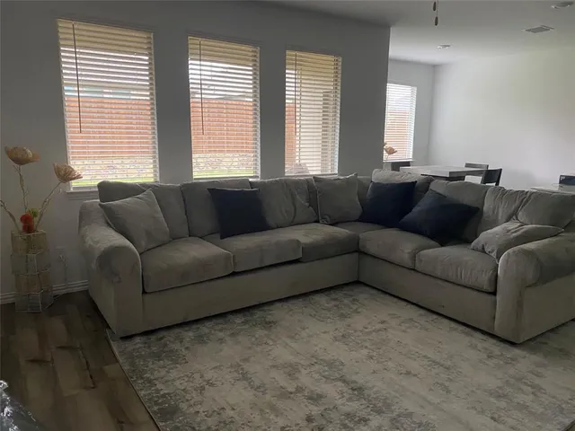 a living room with furniture and windows