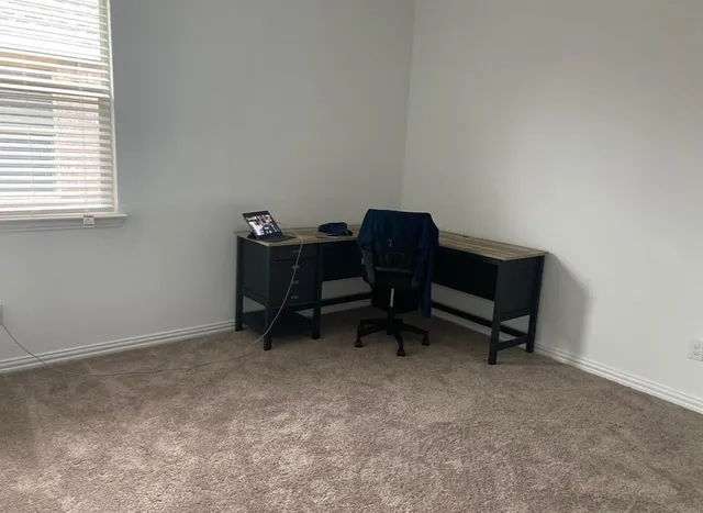 a workspace with furniture and a window