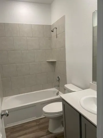 a bathroom with a sink a toilet and a bathtub