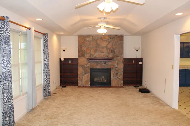 wooden floor in an empty room with a fireplace