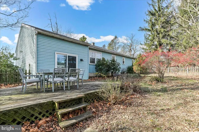 a view of backyard with outdoor seating and plants