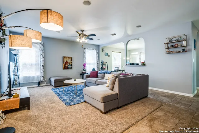 a living room with furniture and a mirror