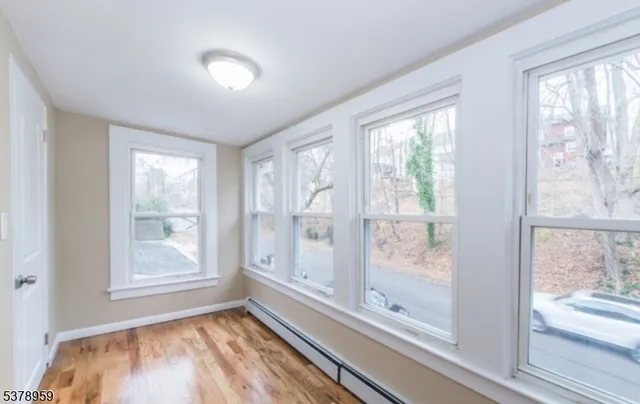 a view of a room that has a large window with front of red walls