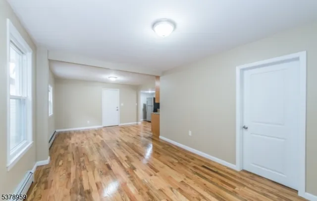 a view of hallway with wooden floor