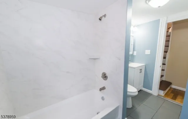 a bathroom with a bathtub and a toilet