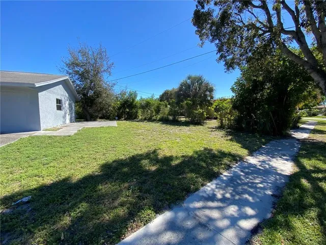 a view of yard with swimming pool and green space