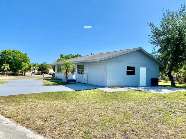 a view of house with yard and swimming pool