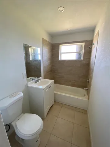 a bathroom with a toilet a sink and bathtub