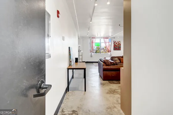 a living room with furniture and a rug