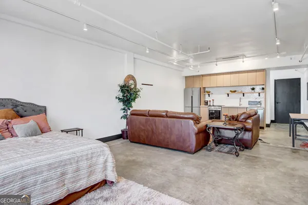 a bedroom with furniture and a large window