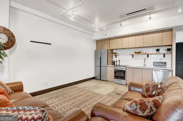 a living room with furniture and a rug