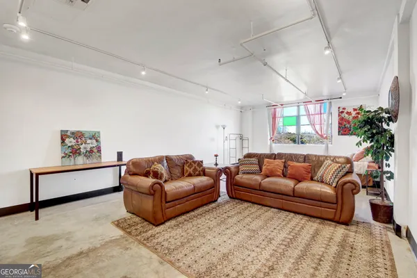 a living room with furniture window and a couch