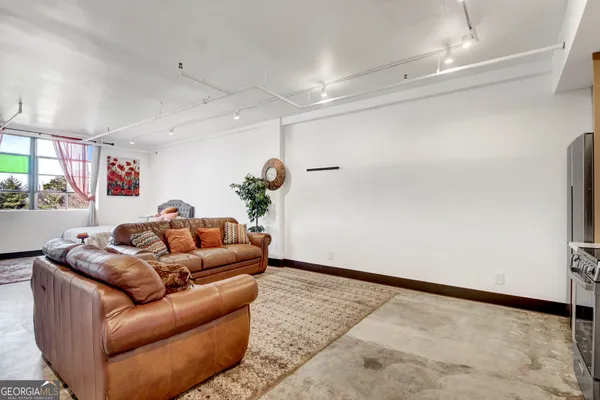 a living room with furniture and a rug