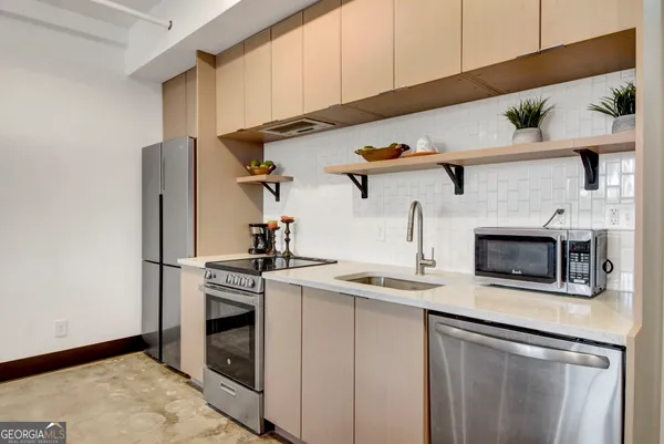 a kitchen with stainless steel appliances granite countertop a stove and a refrigerator