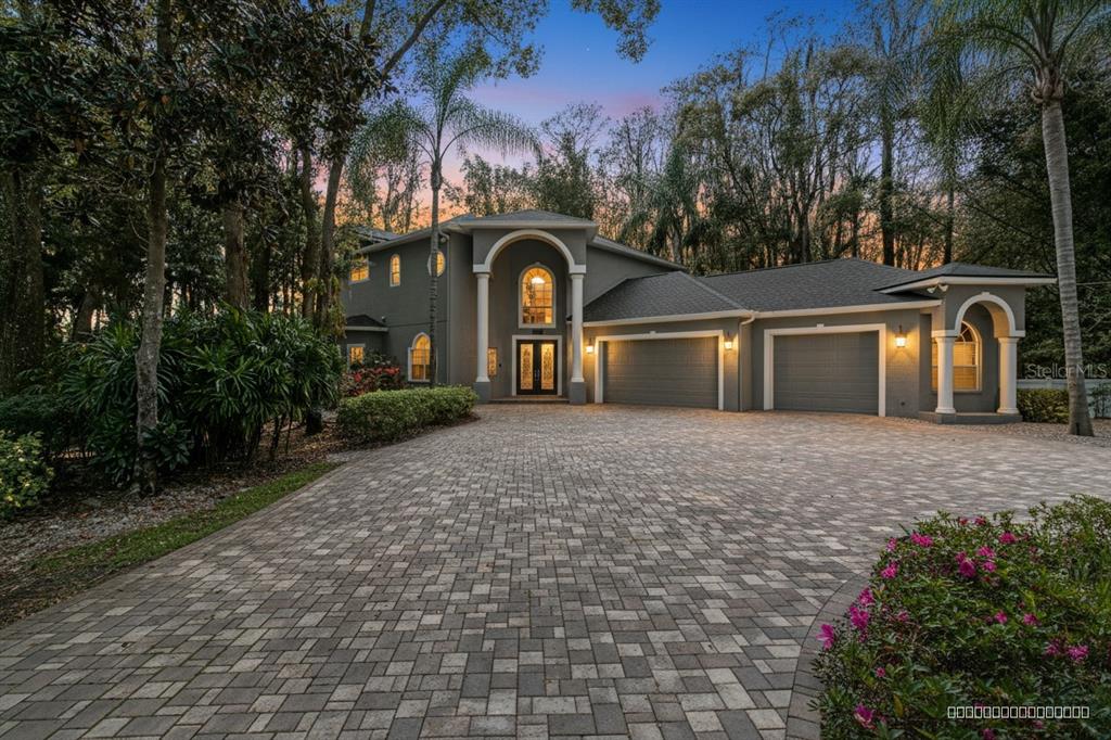 3632 Little Road Lutz, FL 33548 - Photo 1 of 44 a front view of a house with garden