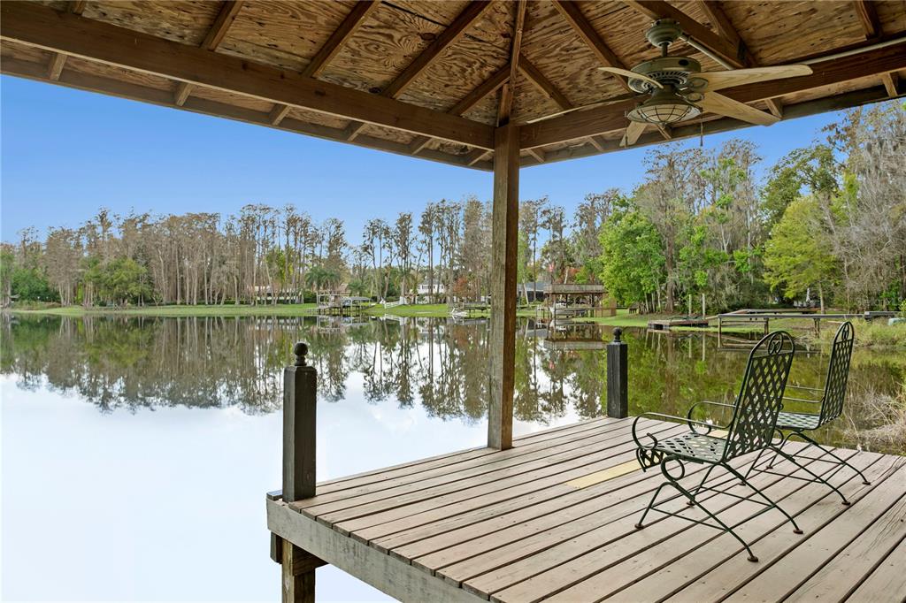 3632 Little Road Lutz, FL 33548 - Photo 19 of 44 a view of a lake with a table and chairs in front of it
