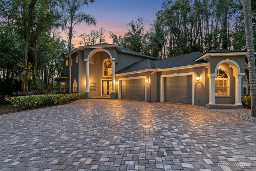 3632 Little Road Lutz, FL 33548 - Photo 2 of 44 a front view of a house with garden