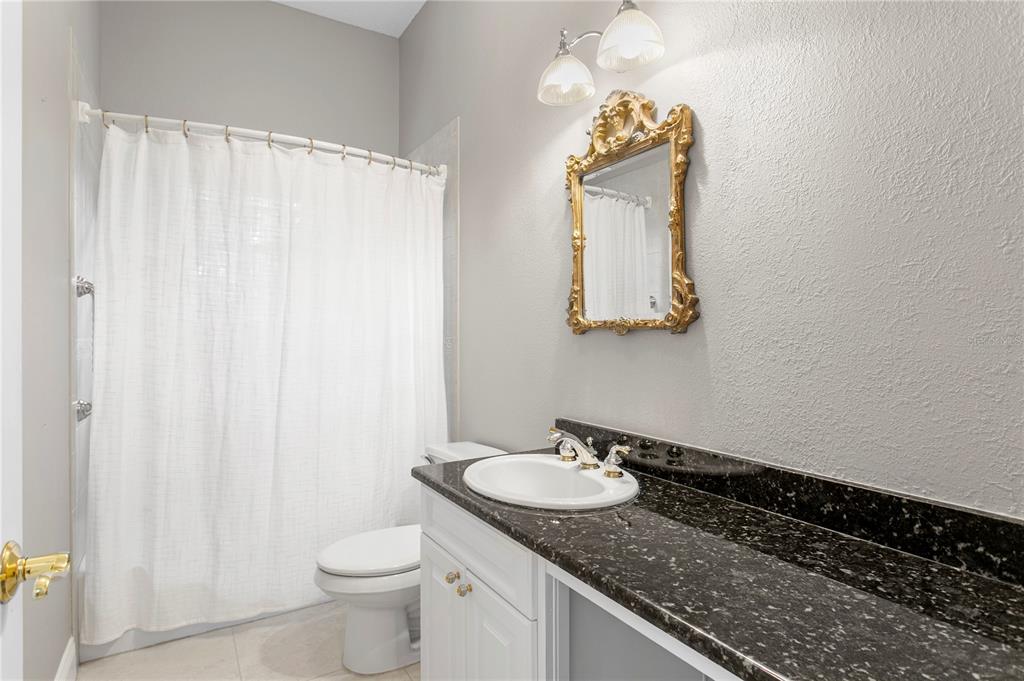 3632 Little Road Lutz, FL 33548 - Photo 30 of 44 a bathroom with a granite countertop sink and a mirror