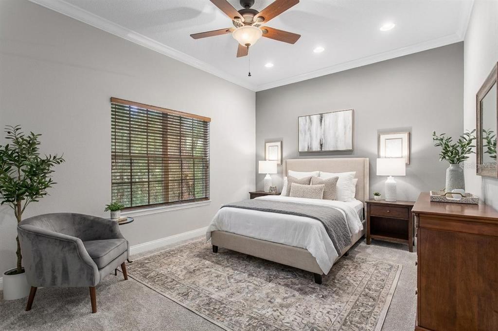 3632 Little Road Lutz, FL 33548 - Photo 31 of 44 a spacious bedroom with a bed and a couch