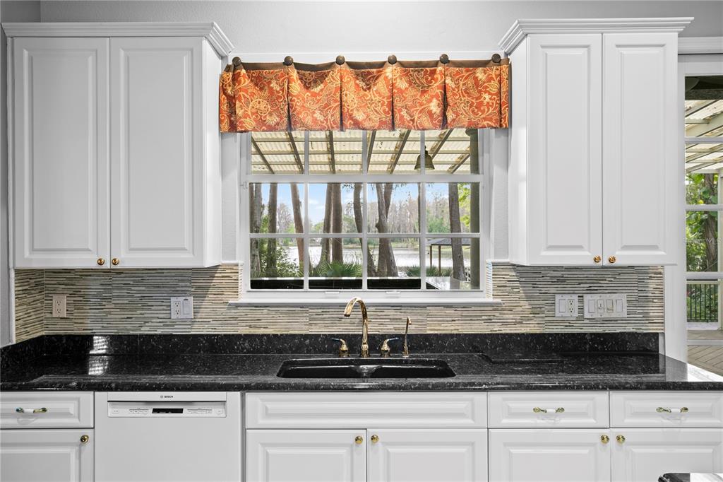 3632 Little Road Lutz, FL 33548 - Photo 7 of 44 a kitchen with stainless steel appliances granite countertop white cabinets and a granite counter tops