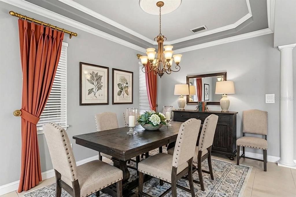3632 Little Road Lutz, FL 33548 - Photo 8 of 44 a view of a dining room with furniture and a chandelier