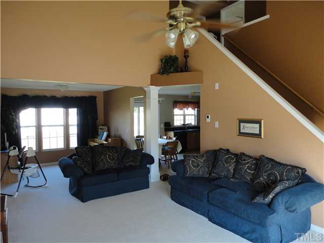 4812 Cardinal Grove Boulevard Raleigh, NC 27616 - Photo 4 of 19 Large, open family room is very bright and inviting. Vaulted ceiling, decorative niche, ceiling fan and gas fireplace