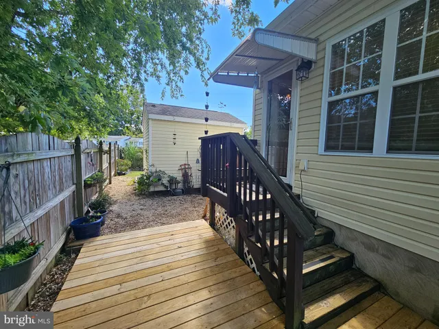 a view of a house with wooden deck