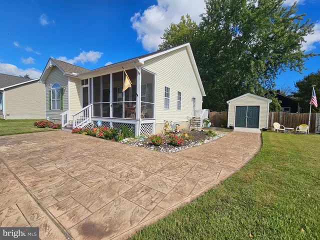 a front view of a house with a yard outdoor seating and barbeque oven