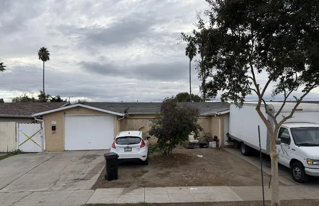 a car parked in front of white house