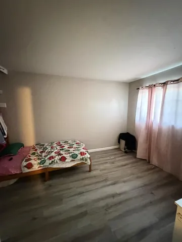 a view of a room with wooden floor