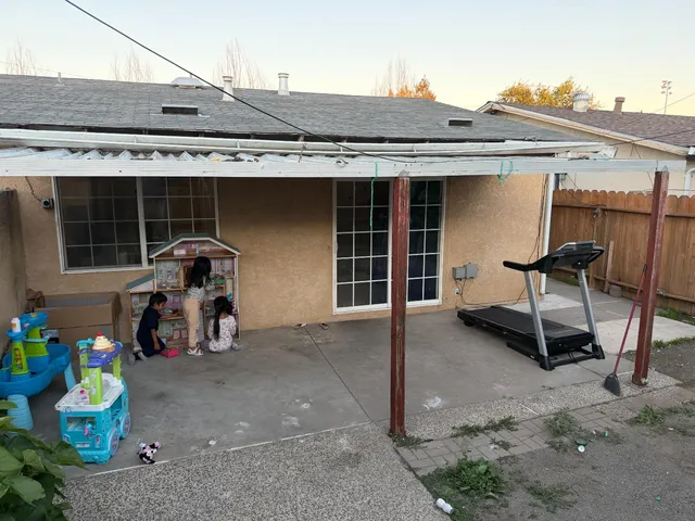 a view of a patio with table and chairs a barbeque and potted plants