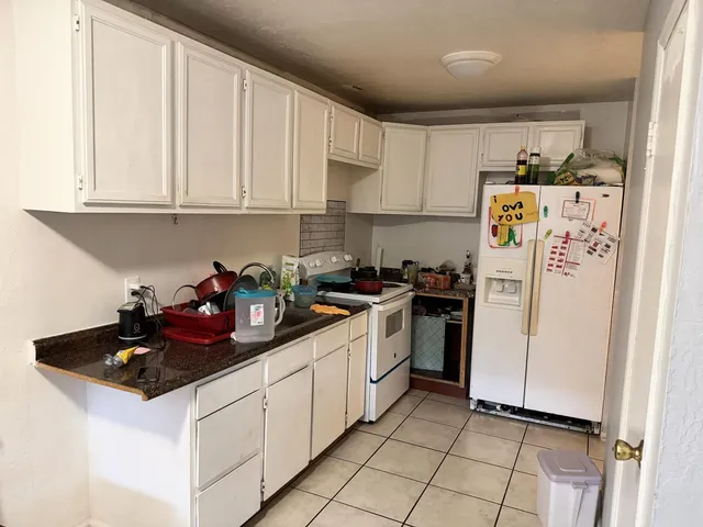 a kitchen with refrigerator a sink and cabinets