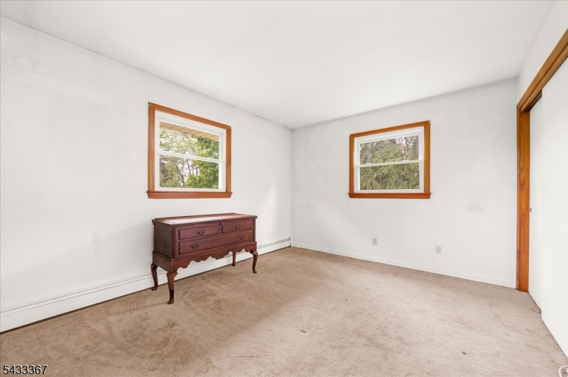650 Woodglen Road Glen Gardner, NJ 08826 - Photo 15 of 28 a view of an empty room with furniture and a window