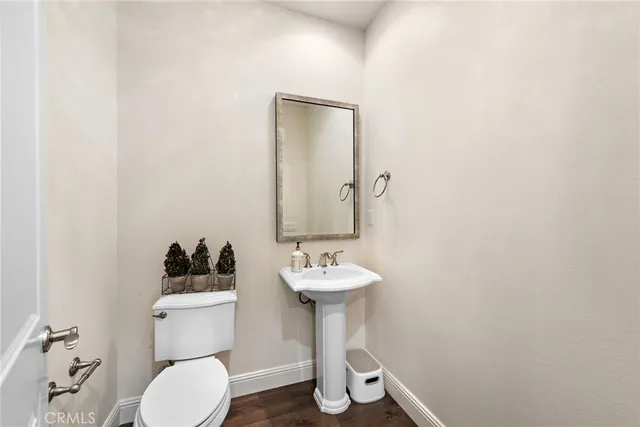 a bathroom with a sink toilet and a mirror
