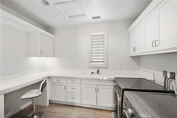 a kitchen with a sink cabinets and window