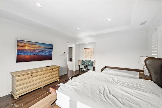 a bedroom with bed tv and couch