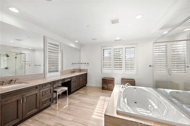 a large bathroom with a large tub sink and window