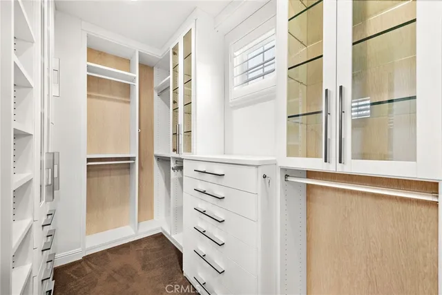 a view of walk in closet with empty racks