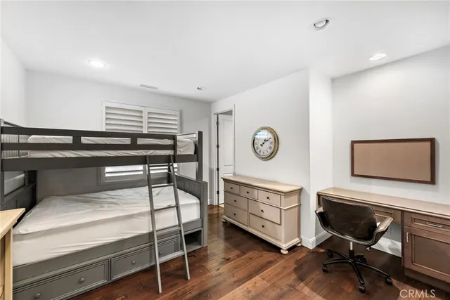 a bedroom with a bed and a desk